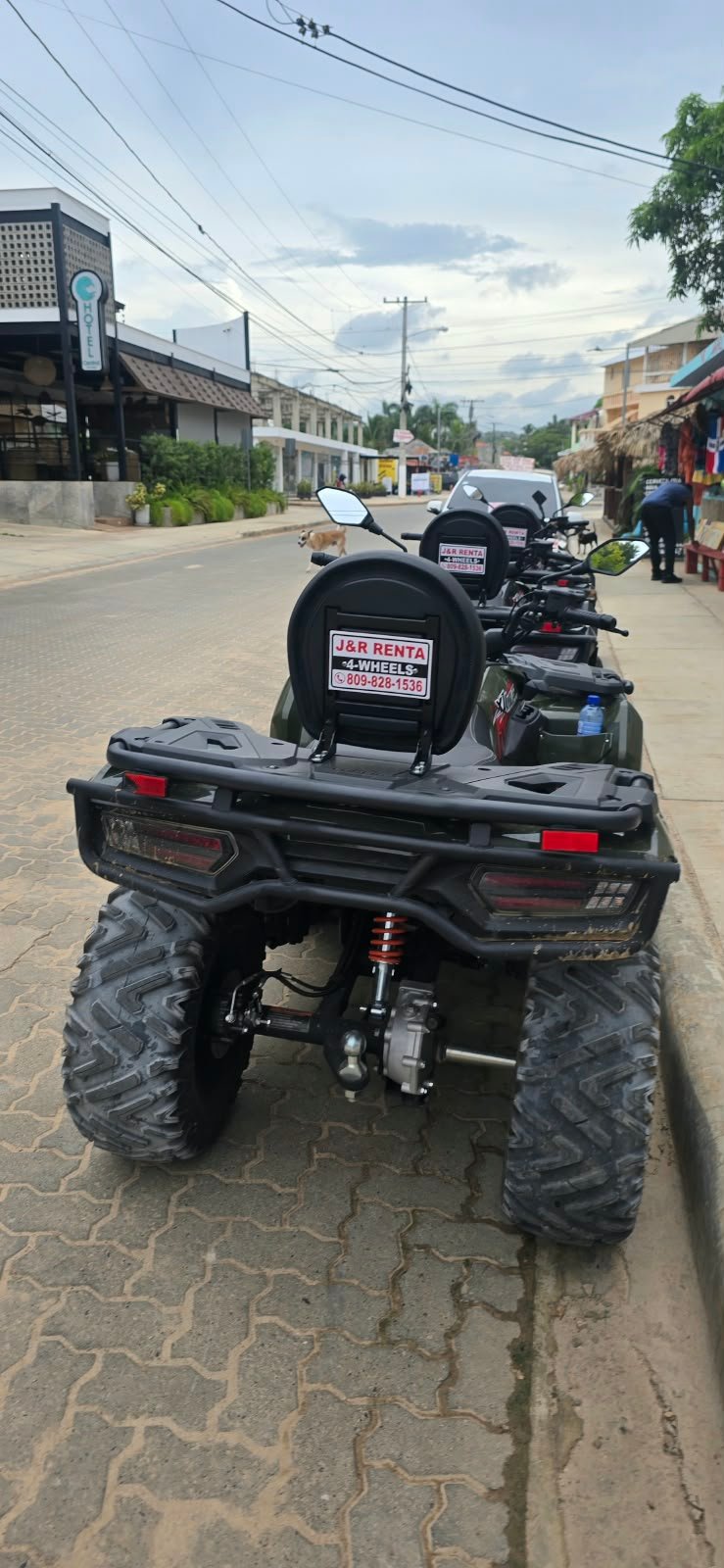 J&R-branded ATVs lined up along a local street